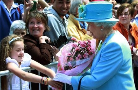 A girl gives Queen Elizabeth some flowers as she walks by well-wishers after visiting the Canadian Museum of Nature in Ottawa, Wednesday June 30, 2010. (THE CANADIAN PRESS/Fred Chartrand)