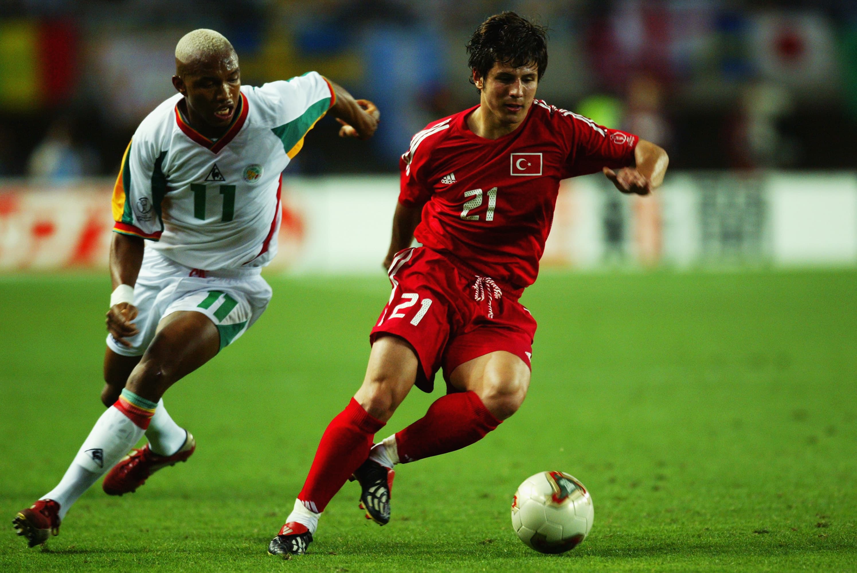 Emre Belozoglu of Turkey and El Hadji Diouf of Senegal