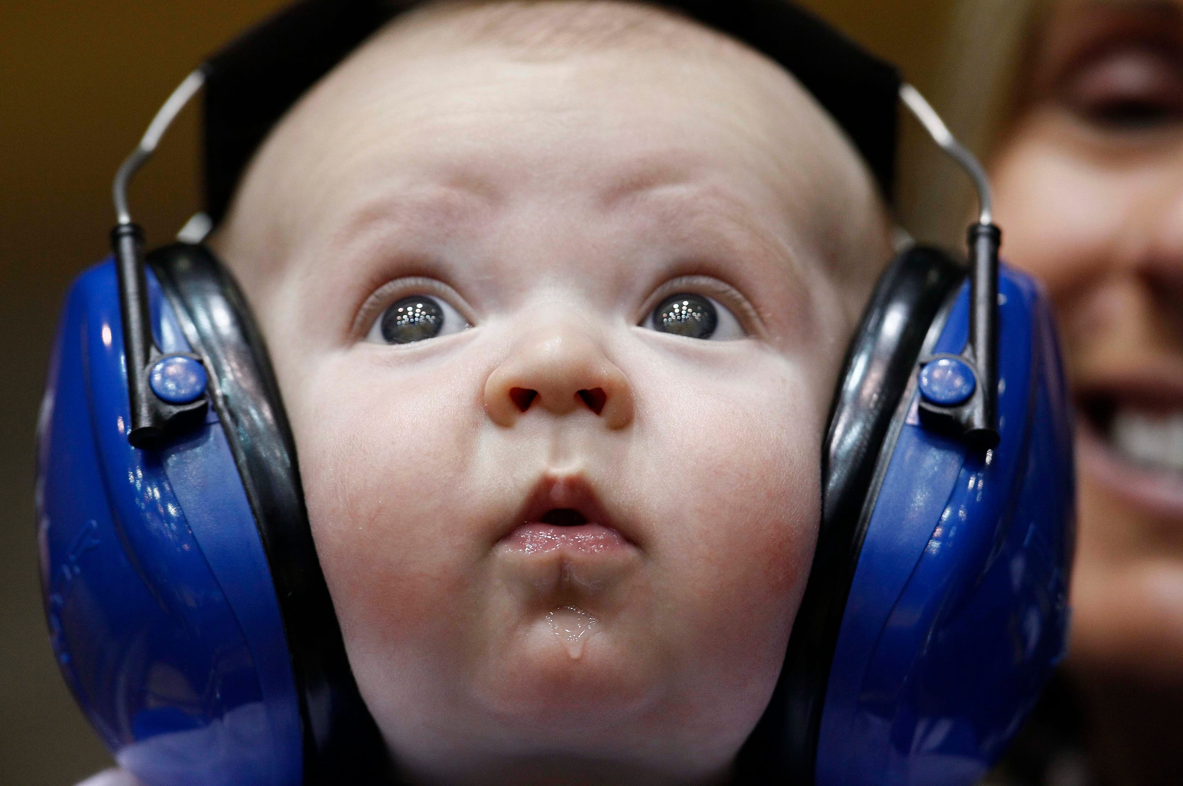 Three-month old Henry Hirschey wears headphones