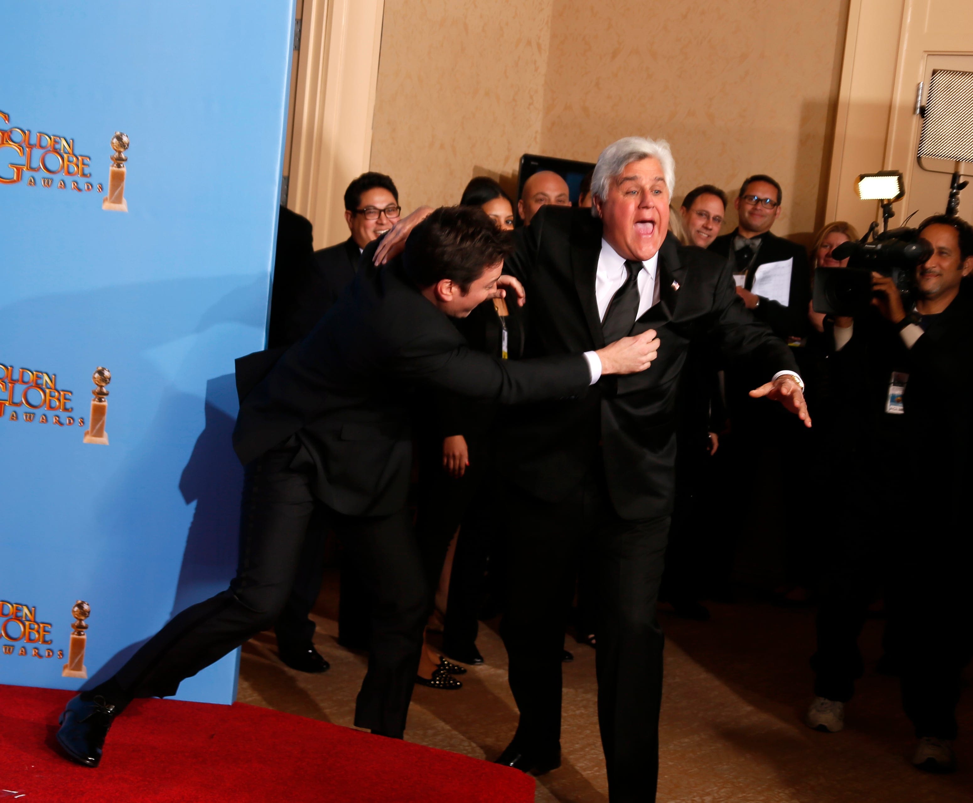 Late night talk show hosts Fallon and Leno joke around backstage at the 70th annual Golden Globe Awards in Beverly Hills