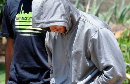 Olympic athlete Oscar Pistorius leaves the Boschkop police station, east of Pretoria, South Africa, Thursday, Feb. 14, 2013 en route to appear in court charged with murder. Olympic athlete Oscar Pistorius was taken into custody and was expected to appear in court Thursday after a 30-year-old woman who was believed to be his girlfriend was shot dead at his home in South Africa's capital, Pretoria. (Chris Collingridge/AP)