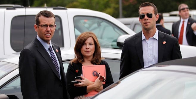 Members of U.S. President Barack Obama's staff, (L-R) Senior Advisor David Plouffe, aide Alyssa Mastromonaco and speechwriter Jon Favreau, are pictured in a parking lot as Obama meets with the spouses of military members in Norfolk, Virginia, July 13, 2012. Obama travelled to Virginia on Friday for campaign events. REUTERS/Jason Reed (UNITED STATES - Tags: POLITICS ELECTIONS) - RTR34WQ8
