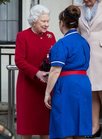 Britain's Queen Elizabeth II, left, shakes hands with the head nurse at the King Edward VII hospital following a one-day stay caused by a stomach ailment, London Monday, March 4, 2013. The 86-year-old queen fell ill Friday and was being treated at Windsor Castle until Sunday, when she was moved to a central London hospital as a precaution. (AP Photo/Alastair Grant)