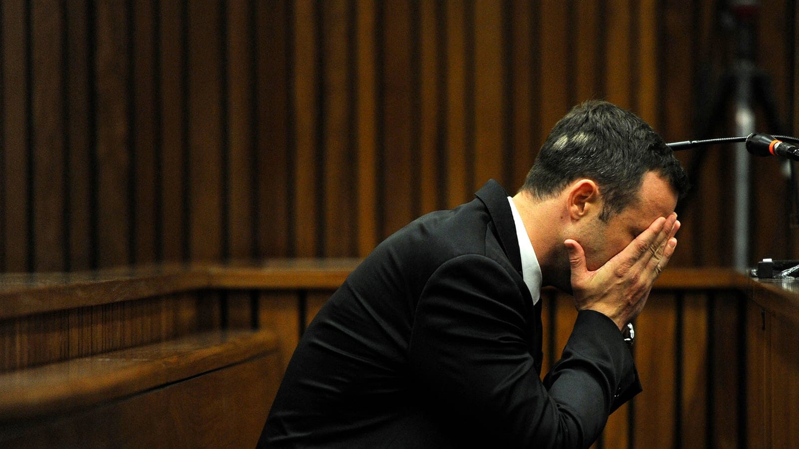Olympic and Paralympic track star Oscar Pistorius reacts during the fourth day of his trial for the murder of his girlfriend Reeva Steenkamp at the North Gauteng High Court in Pretoria