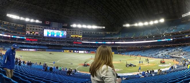 A fan watches as fans stream out of the Rogers Centre on Opening Day.