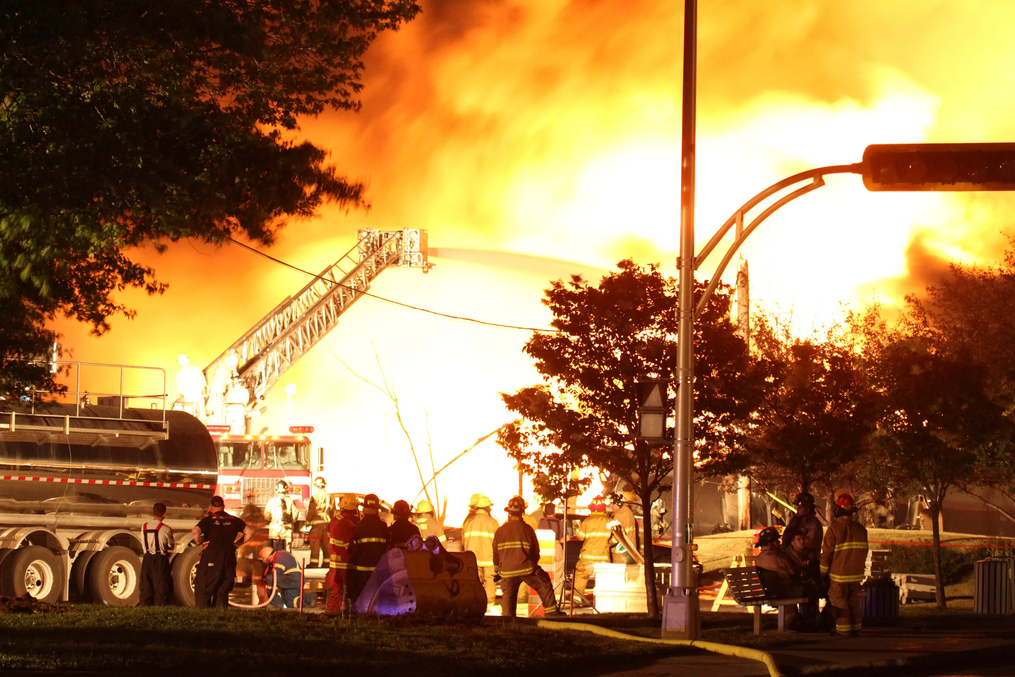 First responders fight burning trains after a train derailment and explosion in Lac-Megantic, Quebec