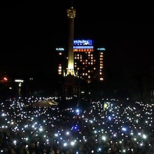 People hold mobile devices as they wait for Ukrainian opposition leader Tymoshenko at a rally in the Independence Square in Kiev