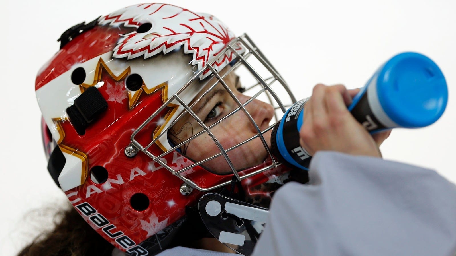 Canada's goalie Szabados takes a drink of water during their women's ice hockey team practice ahead of the 2014 Sochi Winter Olympics