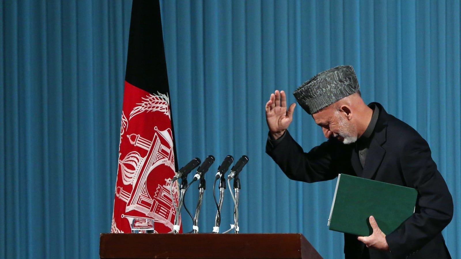 Afghan President Hamid Karzai leaves after a cultural event in Kabul, Afghanistan on Thursday, May 15, 2014. (Massoud Hossaini/AP)