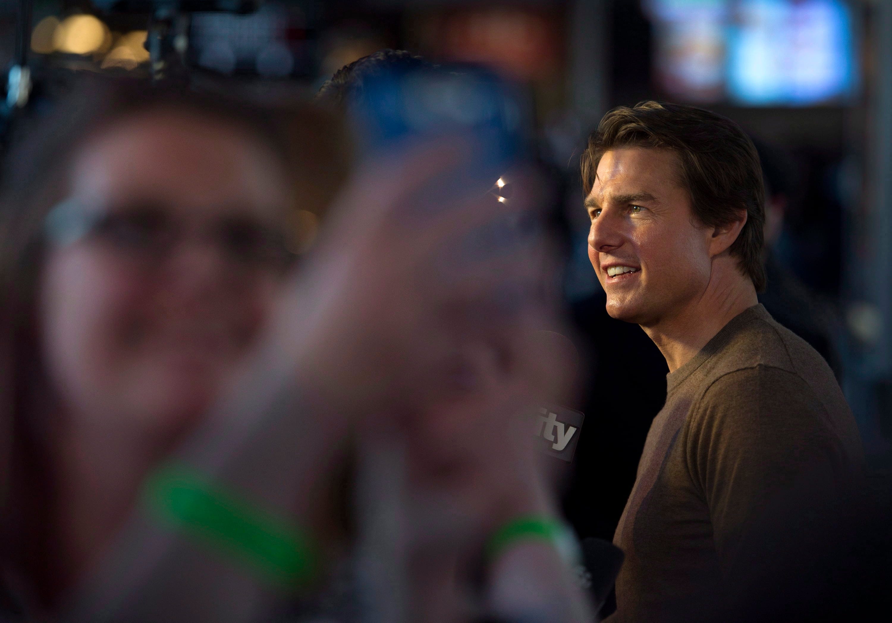 Actor Tom Cruise poses with fans while walking the red carpet at the premiere of his new film "Edge of Tomorrow" in Toronto on Thursday, May 29, 2014. (Darren Calabrese/The Canadian Press)