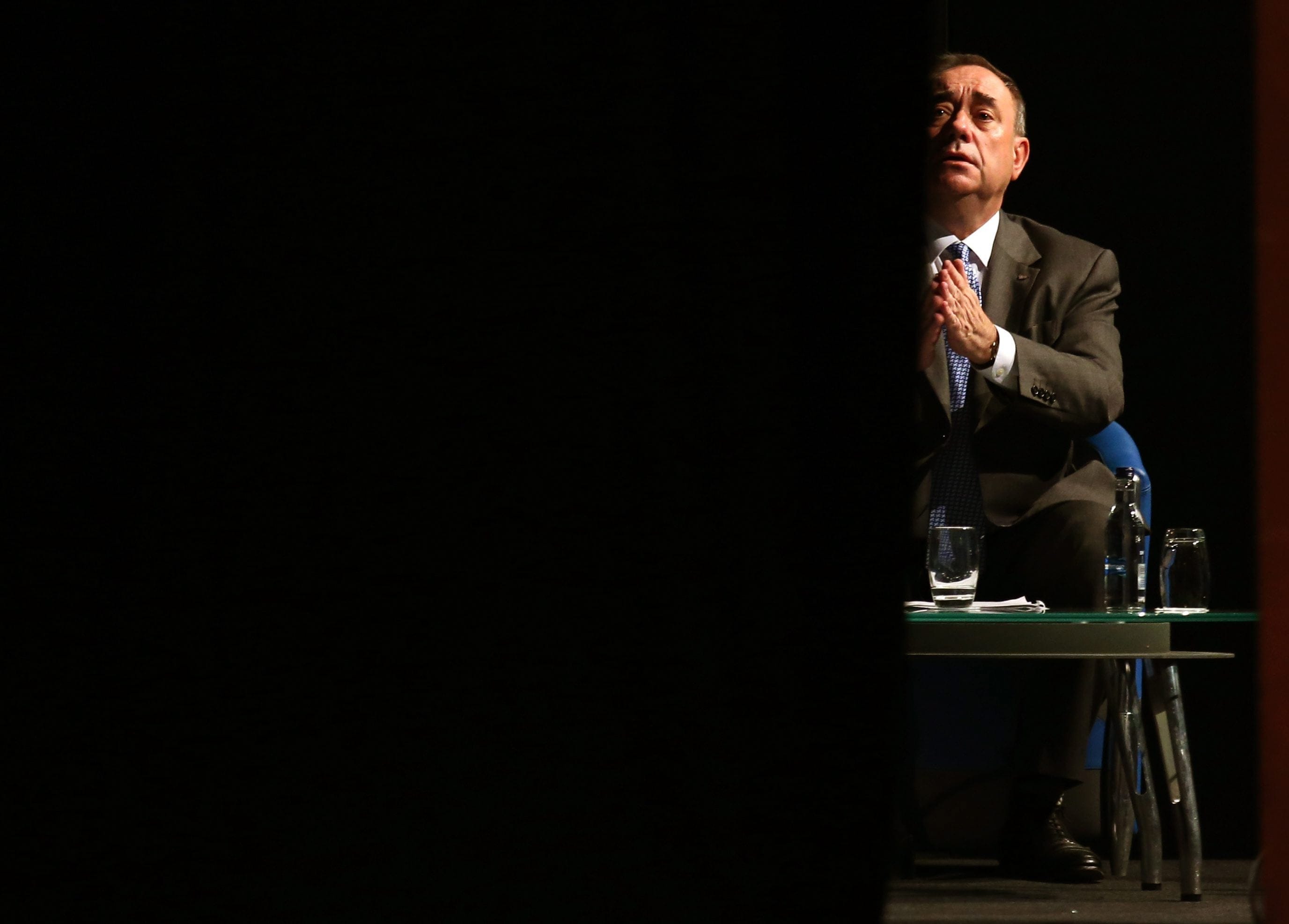 Scottish First Minister Alex Salmond prepares back stage as Nicola Sturgeon speaks on stage to an audience of international journalists exactly 17 years since the country voted Yes to devolution at the Edinburgh International Conference Centre, Thursday, Sept. 11, 2014. (Andrew Milligan/The Associated Press)