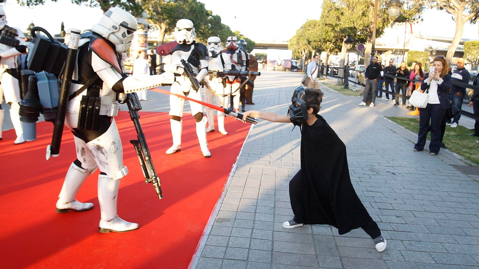 A child with a toy lightsaber plays with a man dressed up as a stormtrooper from the Star Wars movies during a tourism event at Habib Bourguiba Avenue in Tunis. (Zoubeir Souissi/REUTERS)