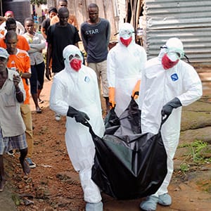 Health workers remove the body of Prince Nyentee, a man whom local residents said died of Ebola virus in Monrovia