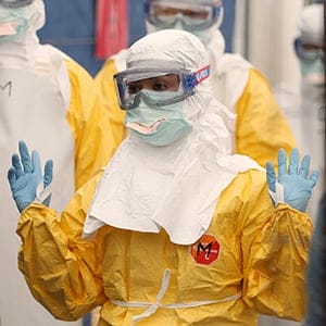 Volunteers for Medecins Sans Frontieres receive training on how to handle personal protective equipment during courses in Brussels