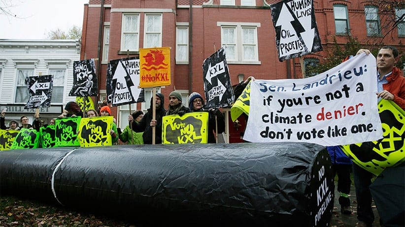 Climate advocates and representatives from the Rosebud Sioux Tribe in South Dakota protest against the Keystone XL pipeline in front of the home (center) of U.S. Senator Mary Landrieu (D-LA), chair of the Senate Energy Committee, in Washington November 17, 2014. (Gary Cameron/Reuters)