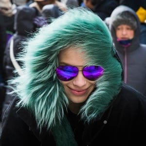 A model protects herself from cold wind as she leaves a presentation of the Victoria Beckham Fall/Winter 2015 collection during New York Fashion Week