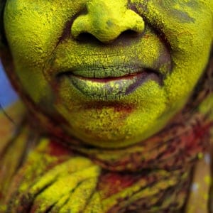 The face of a widow daubed in colour after she took part in Holi celebrations organised by non-governmental organisation Sulabh International at widows' ashram at Vrindavan