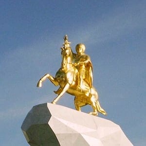 People gather for the monument unveiling ceremony in Ashgabat, Turkmenistan Monday, May 25, 2015. The isolated energy-rich Central Asian nation of Turkmenistan has unveiled a gold-leafed statue of the president in a gesture intended to burnish the leader's burgeoning cult of personality. The 21-meter monument presented to the public Monday consists of a statue of President Gurbanguly Berdymukhamedov atop a horse mounted on a towering pile of marble. (AP Photo/Alexander Vershinin)
