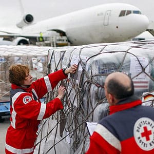 Workers of the German Red Cross (DRK) prepare a load of humanitarian aid for victims of the earthquake in Nepal, in front of an aircraft at Schoenefeld airport outside Berlin April 27, 2015. The flight will carry around 60 tonnes of supplies for the victims. (Hannibal Hanschke/Reuters)