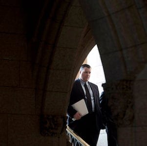 Canadian Heritage and Official Languages Minister James Moore walks to a news conference to discuss victims and crime Thursday Dec.13, 2012 in the foyer of the House of Commons Thursday December 13, 2012 in Ottawa. THE CANADIAN PRESS/Adrian Wyld