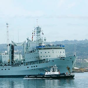 The Royal Canadian Navy ship HMCS Protecteur arrives at Joint Base Pearl Harbor Hickam after it was towed by the U.S. Navy ship USS Sioux after a fire disabled it while at sea in Honolulu, Hawaii, March 6,2014. (Hugh Gentry/Reuters)