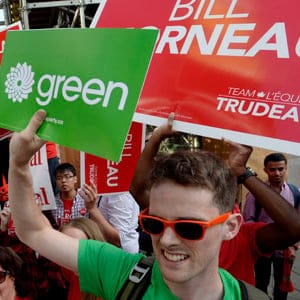 Green Party and Liberal Party supporters cheer outside the venue of the first televised leaders' debate in Toronto on Thursday, August 6, 2015. (Paul Chiasson/CP)