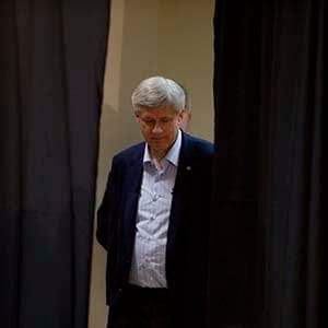 Conservative Leader Stephen Harper is seen backstage as he makes his way through the curtain during a campaign stop in Victoriaville, Que., Friday, September 11, 2015. (Adrian Wyld/CP)