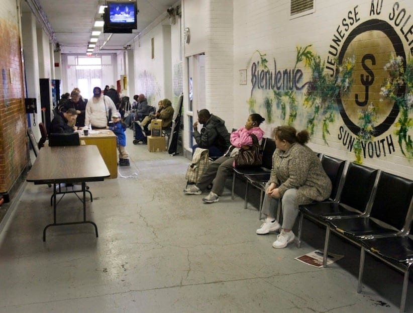 People wait for food baskets at the Sun Youth food bank in Montreal Thursday, April 9, 2009. Statistics Canada reported Thursday that Canada lost another 61,300 jobs in March, taking the unemployment rate up three-tenths of a point to eight per cent for the first time in seven years. THE CANADIAN PRESS/Ryan Remiorz