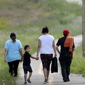 A family of evacuees from wildfires near LaRonge, Saskatchewan (R-L), Franklin Thomas, Rose Thomas, Kassius Thomas, 5, and Emily Thomas walk to a shopping centre from the Energy Centre in Cold Lake, Alberta, July 7, 2015. (Dan Riedlhuber/Reuters)