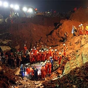 Rescuers search for survivors in the rubble of collapsed buildings on December 22, 2015 in Shenzhen, China. The number of missing people was revised to 76 from 91 after a landslide hit an industrial park and buried 33 buildings in Shenzhen city on Sunday. (ChinaFotoPress/Getty Images)