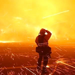 Fire photographer Tod Sudmeier gets hit with flying embers from strong winds at the Solimar brush fire that started early Saturday morning in Ventura County, California December 26, 2015. A wildfire in Southern California burned over 1,000 acres of land, forced the closure of parts of two major highways and led to evacuations on Saturday, fire officials said. (Gene Blevins/Reuters)