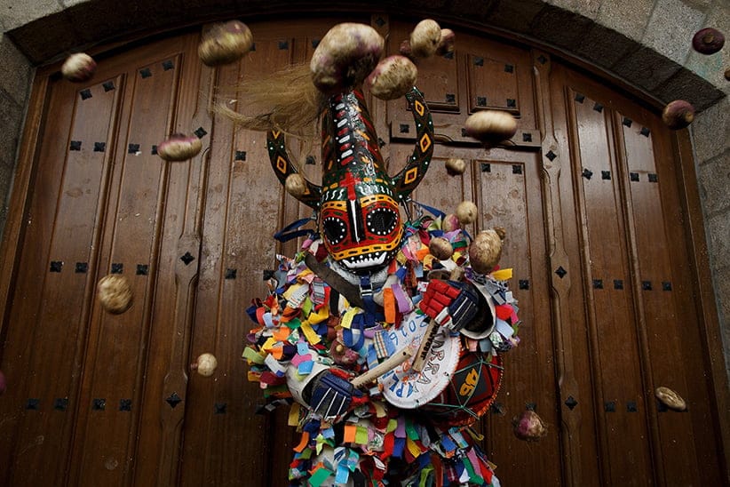 People throw turnips at the Jarramplas as he comes out from the church beating his drum during the Jarramplas Festival on January 20, 2016 in Piornal, Caceres province, Spain. (Pablo Blazquez Dominguez/Getty Images)