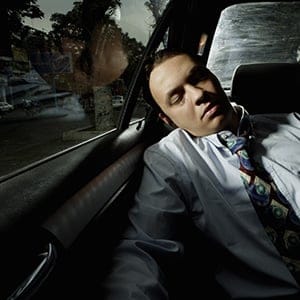 Man sleeping in back of car. (A.B./Getty Images)