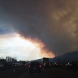 Heavy smoke rises above Memorial Drive, in Fort McMurray, Alberta, southern Canada, as a huge wildfire has forced mass evacuation of the entire population of the Canadian city, on May 3, 2016. (Jacob Braun/CP)