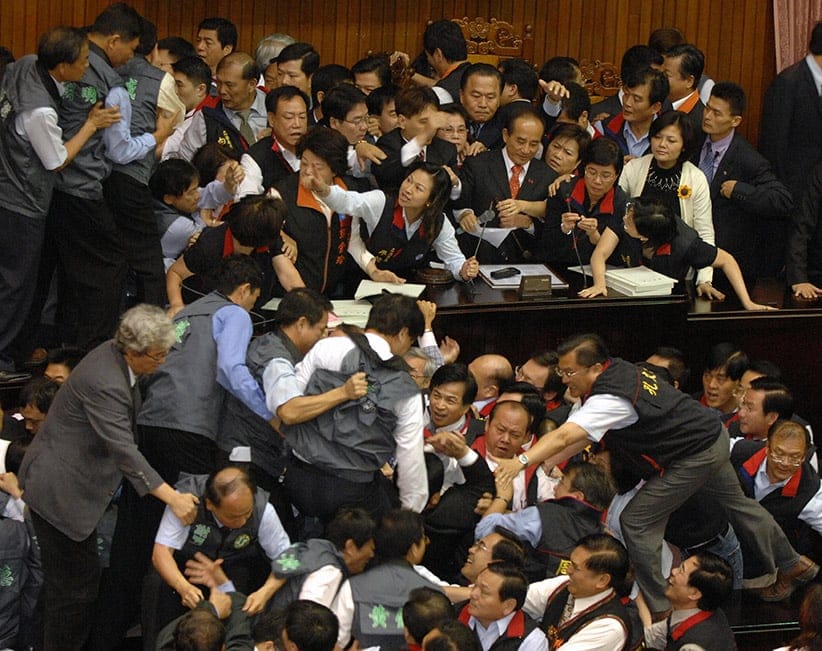 Legislators from the main opposition Kuomintang (KMT) and the ruling Democratic Progressive Party (DPP) push each other while discussing the annual government budget at Parliament, in Taipei, Taiwan on 08 May 2007. SAM YEH/AFP/Getty Images