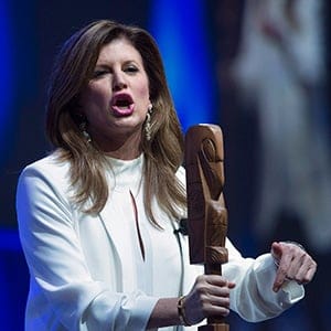 Interim Conservative leader Rona Ambrose holds an aboriginal talking stick as she addresses the audience at the Conservative Party of Canada convention in Vancouver, Friday, May 27, 2016. (Jonathan Hayward/CP)