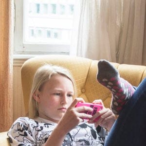 Teen using a smartphone on the couch. (Johner Images/Getty)