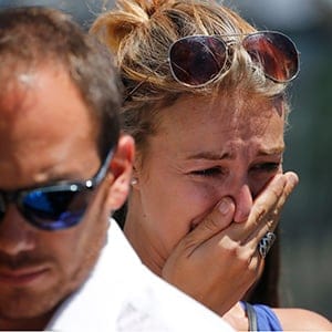 People react near the scene where a truck ran into a crowd at high speed killing scores and injuring more who were celebrating the Bastille Day national holiday, in Nice, France, July 15, 2016. (Jean-Pierre Amet/Reuters)
