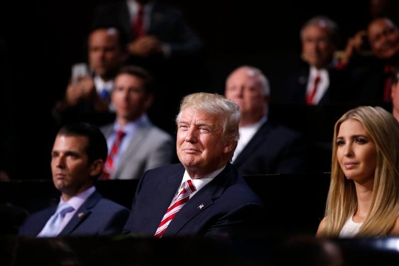 Republican Presidential Candidate Donald Trump, centre, watches with Donald Trump, Jr., left, and Ivanka Trump as his son Eric Trump addresses the delegates during the third day session of the Republican National Convention in Cleveland, Wednesday, July 20, 2016. (AP Photo/Matt Rourke)