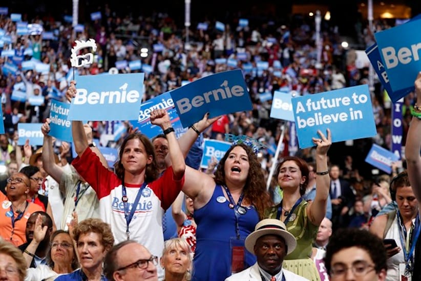Delegates cheer as Former Democratic Presidential candidate, Sen. Bernie Sanders, I-Vt., speaks during the first day of the Democratic National Convention in Philadelphia , Monday, July 25, 2016. (AP Photo/Carolyn Kaster)