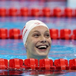 Canada's Penny Oleksiak smiles after winning the gold medal and setting a new olympic record in the women's 100-meter freestyle during the swimming competitions at the 2016 Summer Olympics, Thursday, Aug. 11, 2016, in Rio de Janeiro, Brazil. (AP Photo/Lee Jin-man)