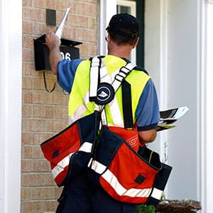A postal worker delivers mail as an ongoing labour dispute between the Canadian Union of Postal Workers and Canada Post continues, Tuesday, July 5, 2016 in Ottawa. (Justin Tang/CP)