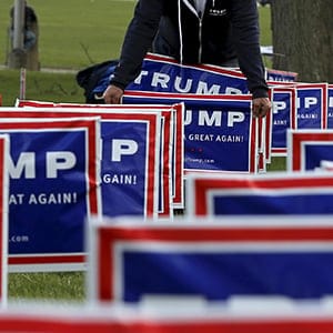Elam Stoltzfus plants lawn signs outside a U.S. Republican presidential candidate Donald Trump campaign rally in West Allis, Wisconsin, United States, April 3, 2016. REUTERS/Jim Young - RTSDEJT