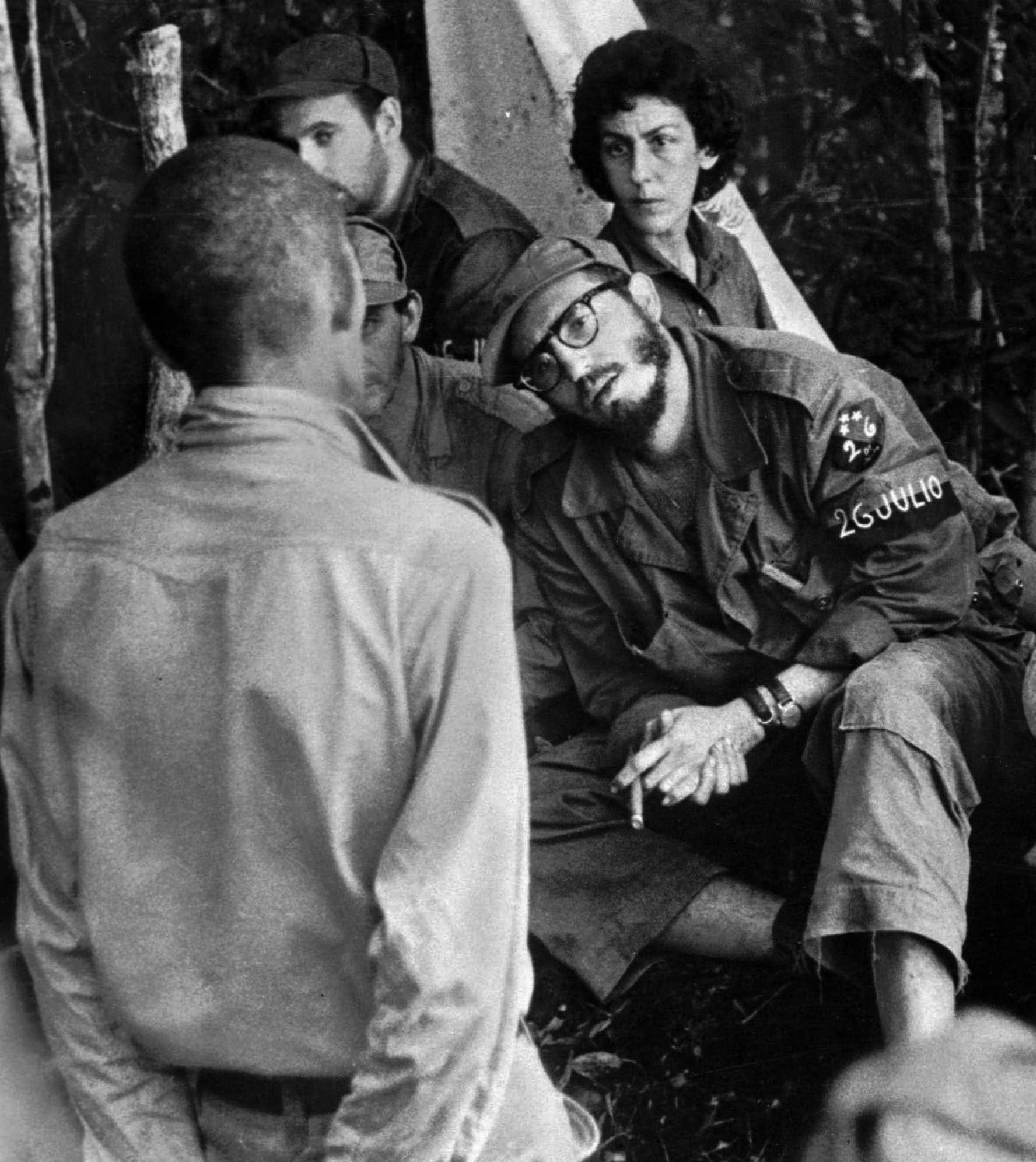 FILE - In this 1958 file photo, Cuba's leader Fidel Castro, center, questions a man charged with banditry as Celia Sanchez looks on during a trial held in the guerrillas' base in the Cuban mountain range of Sierra Maestra. For a quarter century fellow revolutionary Celia Sanchez was Castro's confidante and closest aide before dying of cancer in 1980. President Raul Castro said on state television that his older brother died late Friday, Nov. 25, 2016. He was 90. (AP Photo/Andrew St. George, File)