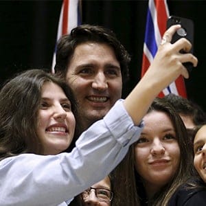 Canada's Prime Minister Justin Trudeau (C) poses for a selfie with students during the First Ministers' meeting in Ottawa, Canada November 23, 2015. (Chris Wattie/Reuters)