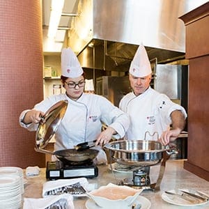 Red River College student and teacher cooking at Jane's