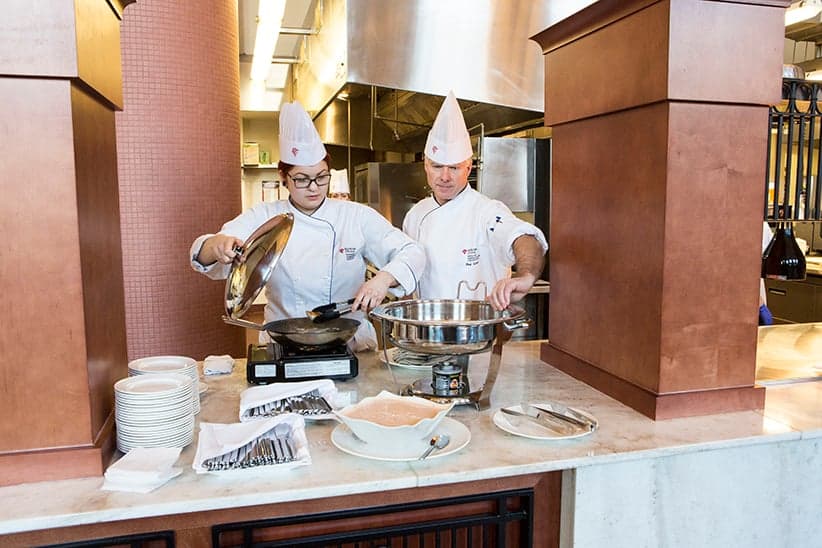 Red River College student and teacher cooking at Jane's