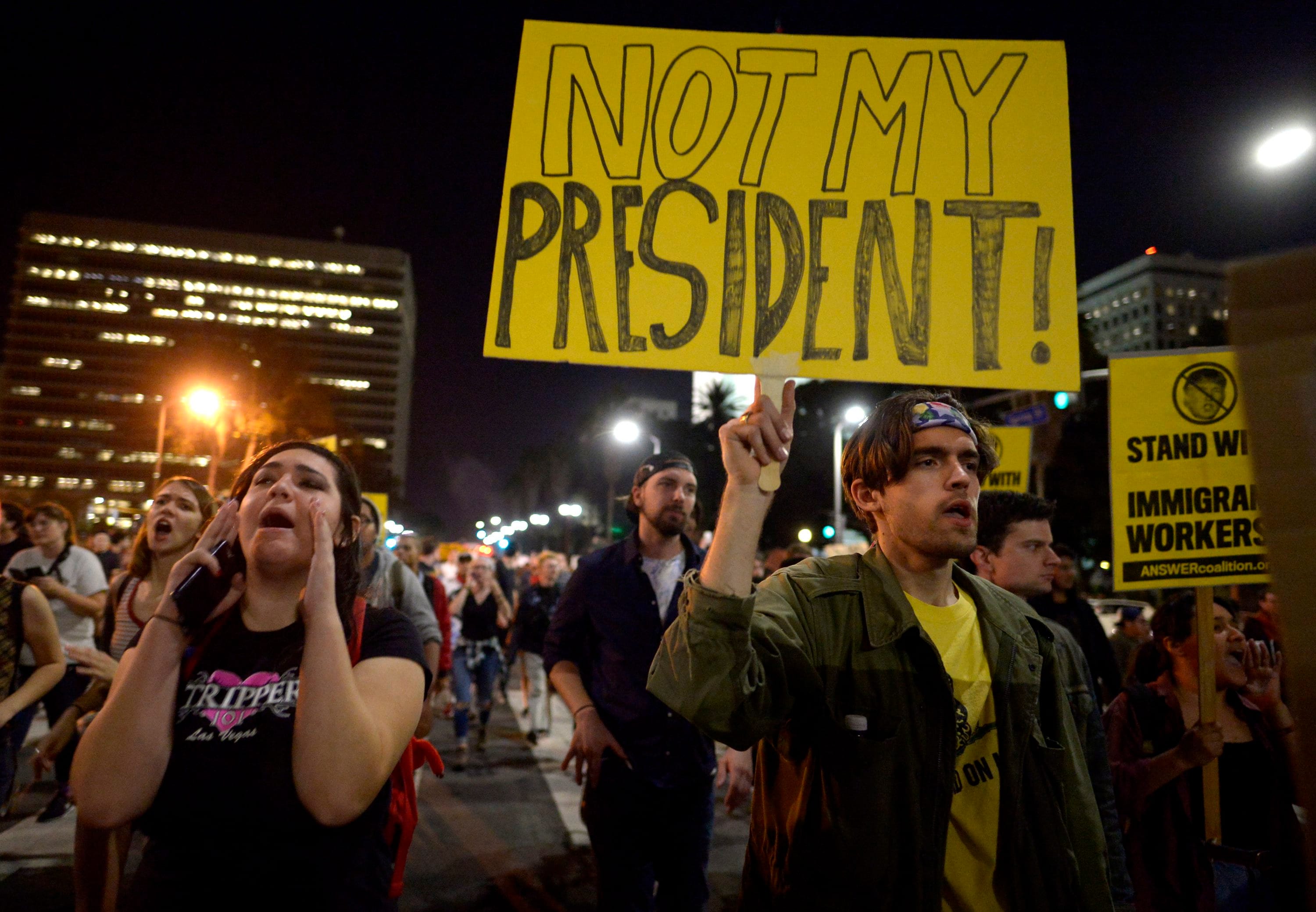 Protesters march through downtown along Spring Street during a protest against President-elect, Donald Trump, Wednesday, Nov. 9, 2016 in Los Angeles. A day after Trumps election as president, the divisions he exposed only showed signs of widening as many thousands of protesters flooded streets across the country to condemn him. (Keith Birmingham/The Pasadena Star-News/SCNG via AP)
