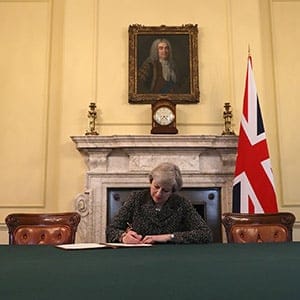 Britain's Prime Minister Theresa May, sits below a painting of Britain's first Prime Minister Robert Walpole, as she signs the official letter to European Council President Donald Tusk, invoking Article 50 and signalling the United Kingdom's intention to leave the EU, in the cabinet office inside 10 Downing Street on March 28, 2017.
British Prime Minister Theresa May will send a letter to EU President Donald Tusk with Britain's formal departure notification on Wednesday, opening up a two-year negotiating window before Britain actually leaves the bloc in 2019. (Christopher Furlong/AFP/Getty Images)