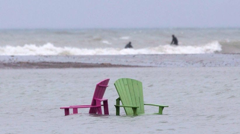 Chairs stand partially submerged on the beach at Toronto's Ashbridges Bay on Friday May 5, 2017 as continuous heavy rain causes flooding issues across the city. THE CANADIAN PRESS/Chris Young
